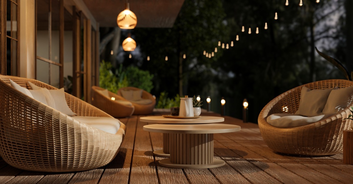 A deck that has multiple basket chairs placed around it. There are many lighting sources spread around the deck as well.