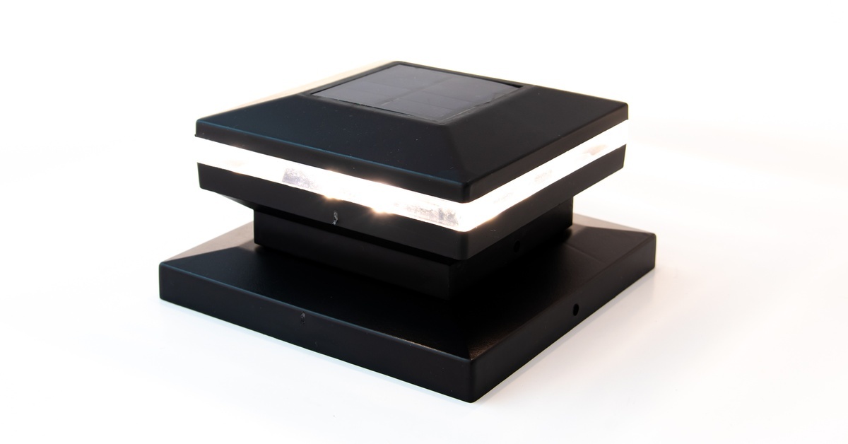 A single solar post cap sitting against a white background. The light inside the cap is currently on.