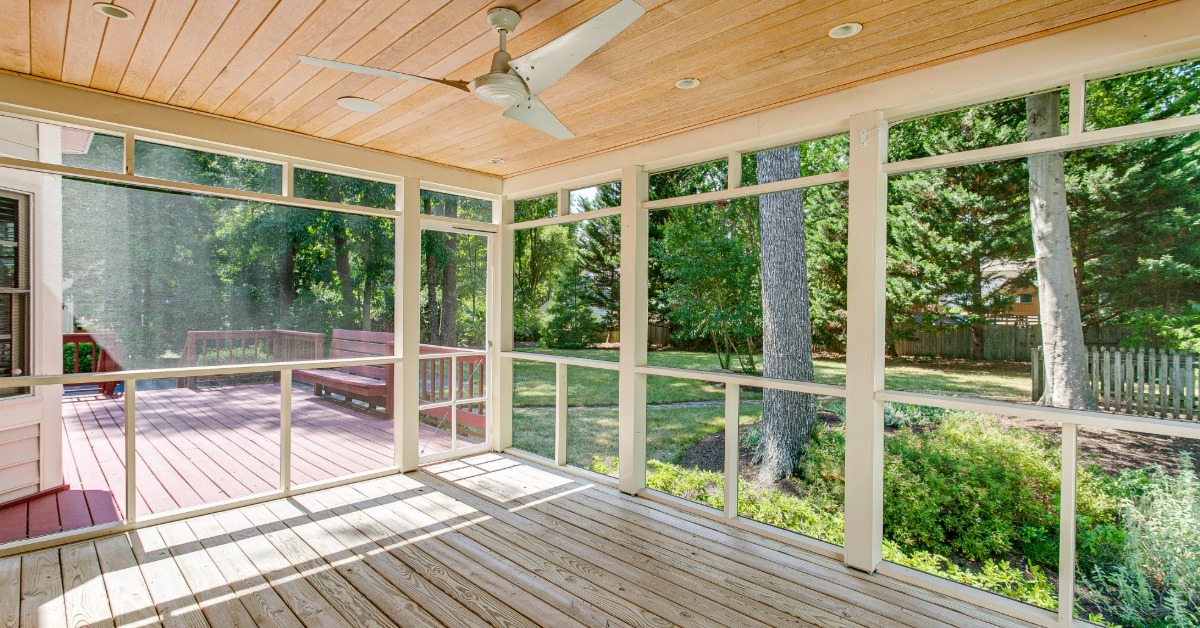 A deck that is split between an outdoor and screened-in section. The screened-in area doesn't have anything in it.